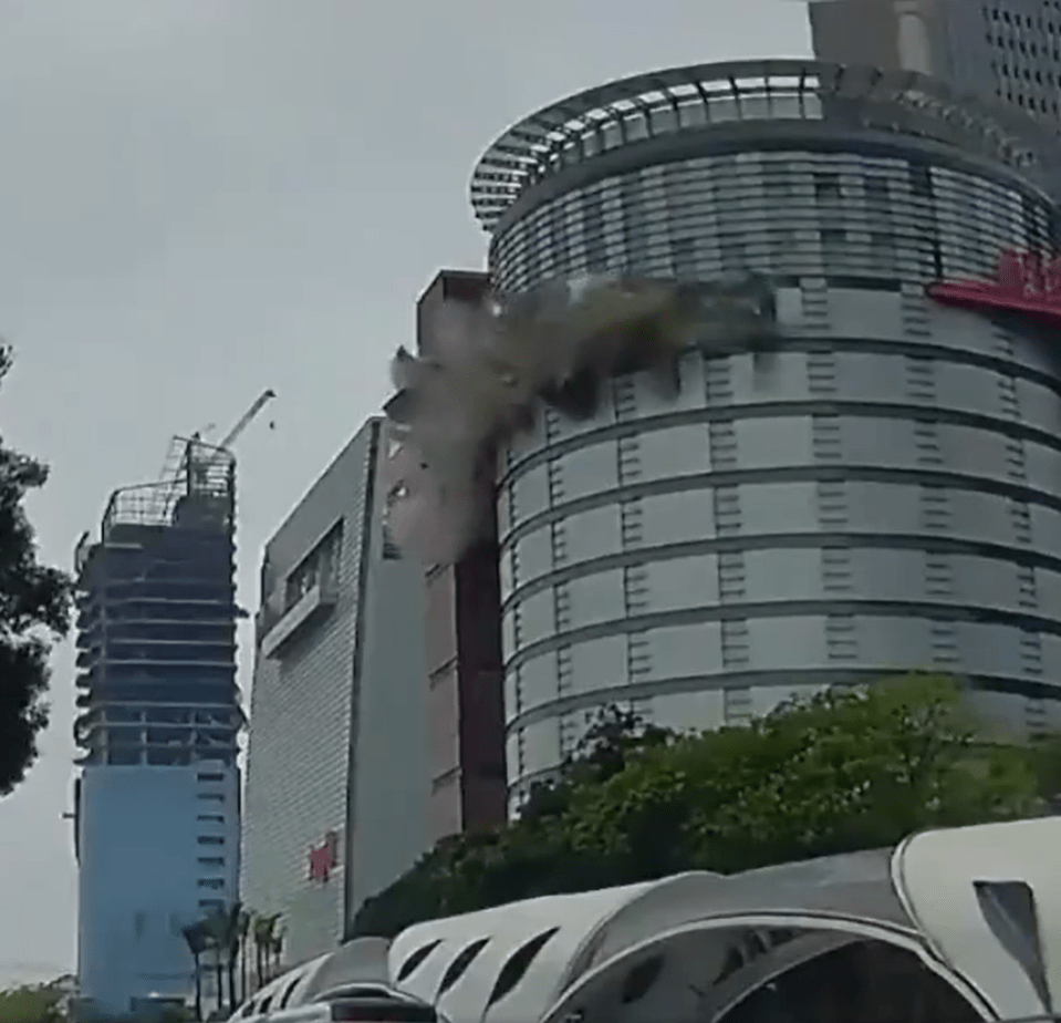 Debris falling from a building, creating smoke.