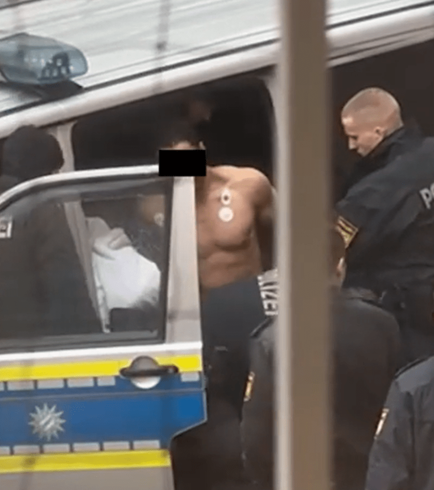 Shirtless man being arrested by police.