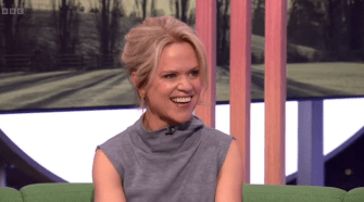 Woman smiling on a talk show.