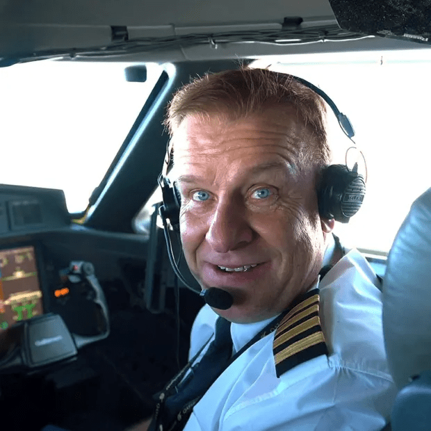 Pilot in cockpit smiling.