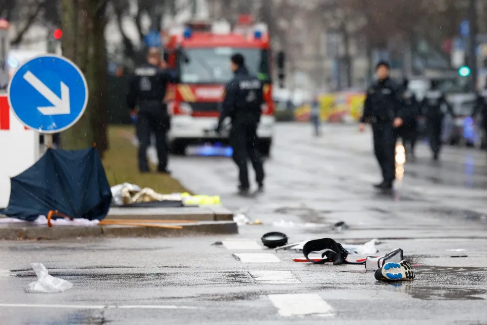 Scattered belongings on a wet street after an accident.