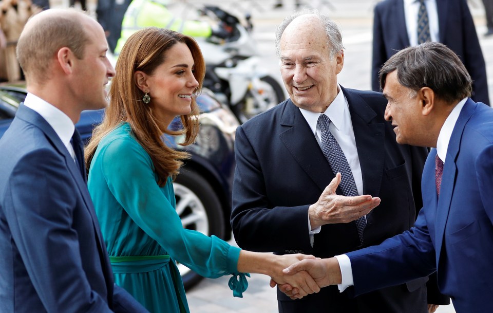 Kate Middleton shaking hands with an older man, while Prince William looks on.