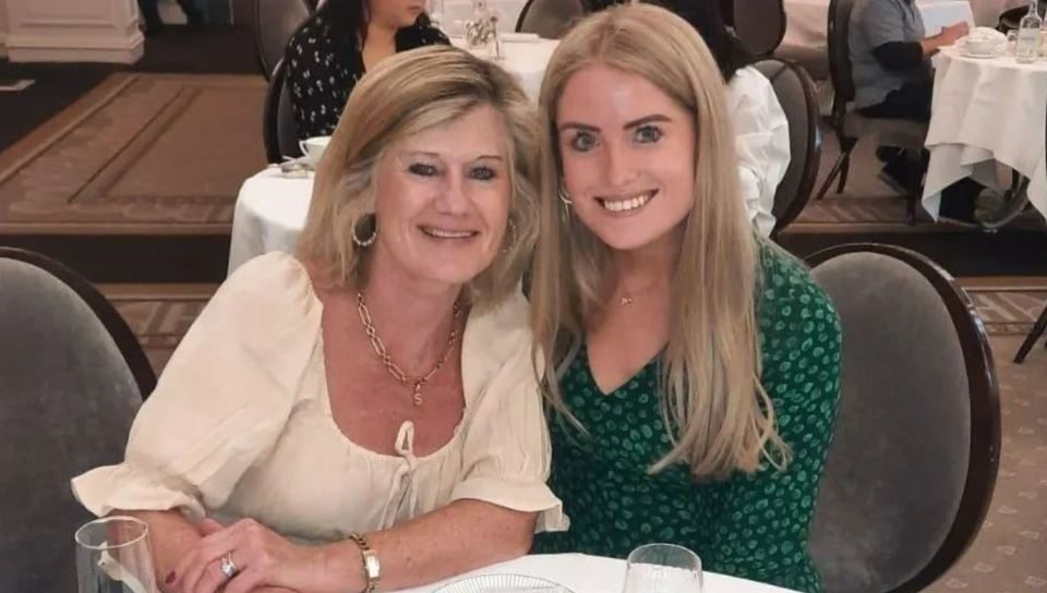 Two women smiling at a table.