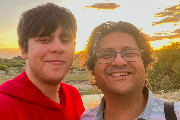 Selfie of a father and son at sunset.