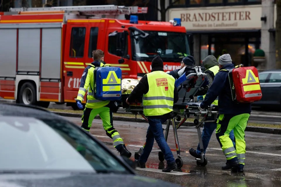 Paramedics transporting a patient on a stretcher.