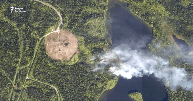 Aerial view of wildfire near a lake.