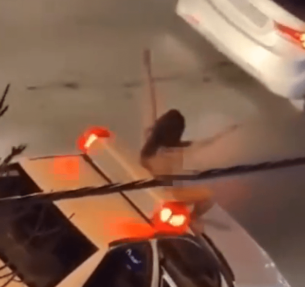 Person on car roof at night.