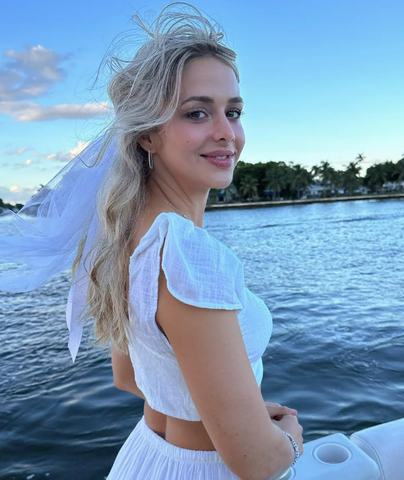 Woman in white outfit on a boat.