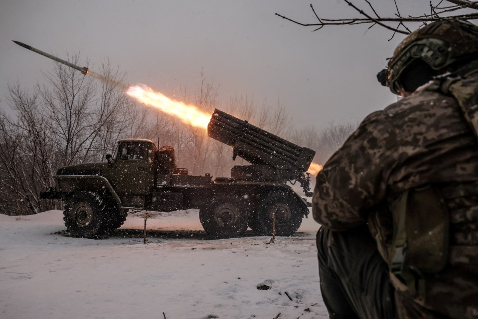 A rocket launcher firing a missile in a snowy landscape, viewed from behind a soldier.