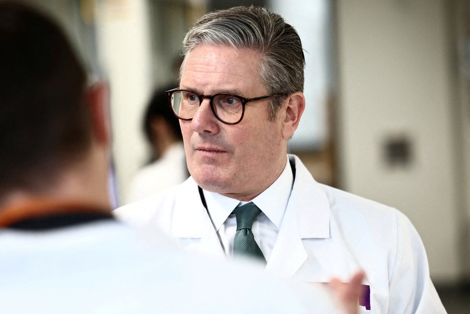 Man in a white coat and glasses.