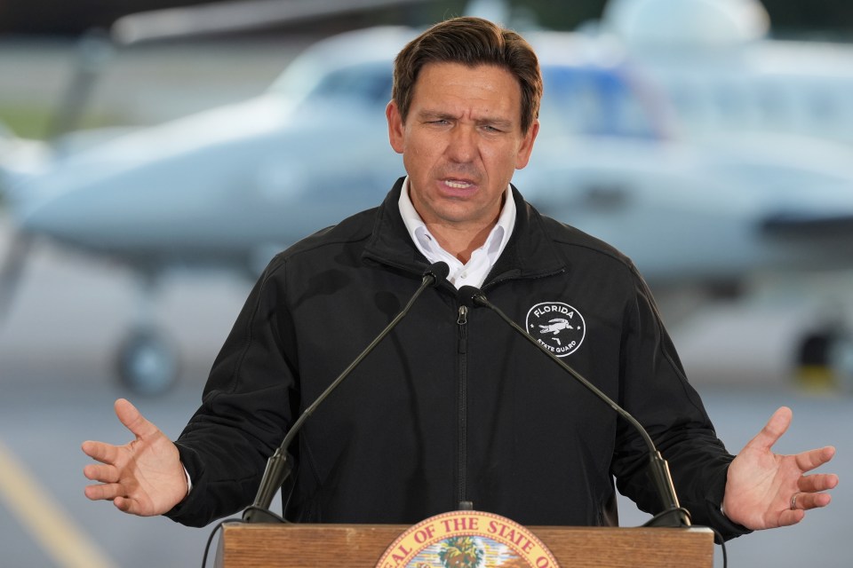 Ron DeSantis speaking at a podium.