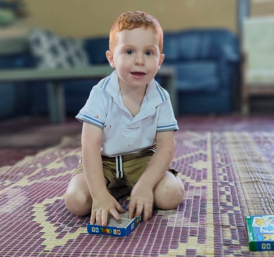 Young boy playing with a toy.