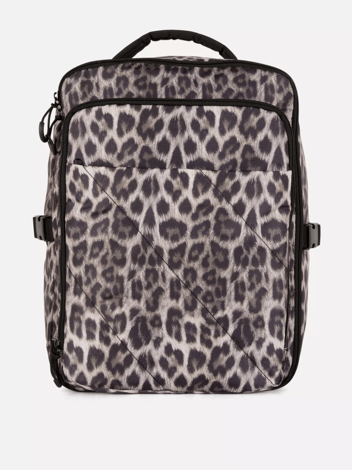 Leopard-print backpack with a top handle.