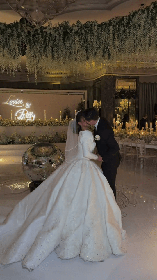 Bride and groom kissing at their wedding reception.