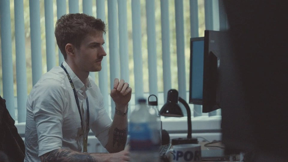 Intelligence analyst reviewing footage at his desk.