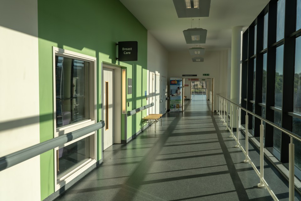 Empty corridor in Royal Stoke University Hospital with breast care signage.