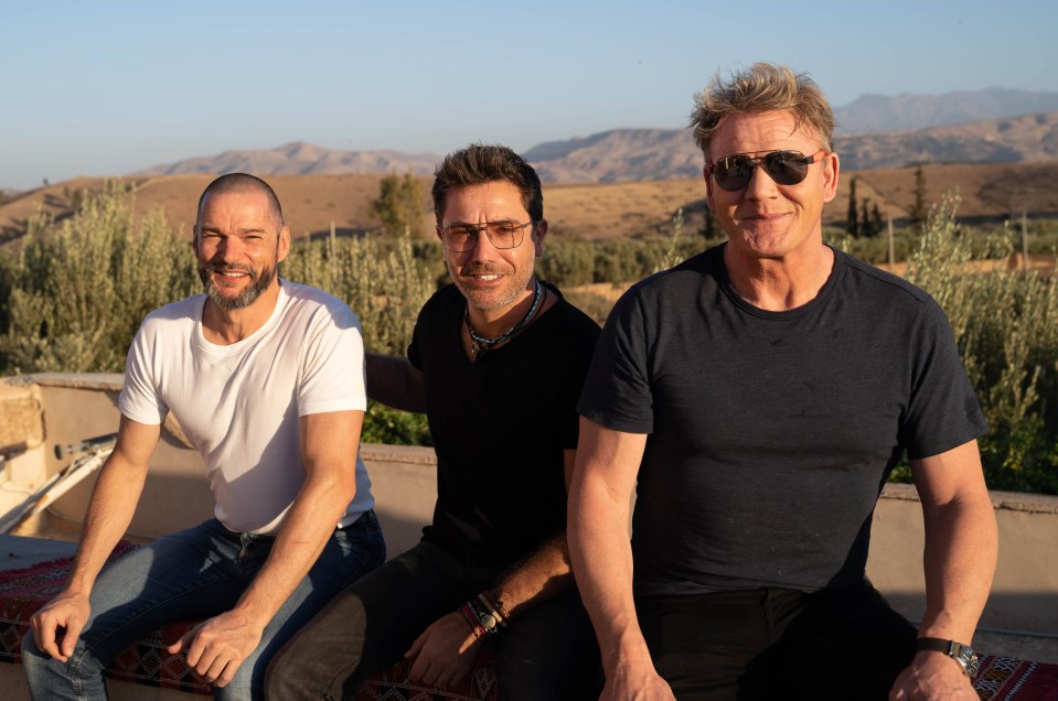 Three men sitting outdoors in Morocco.