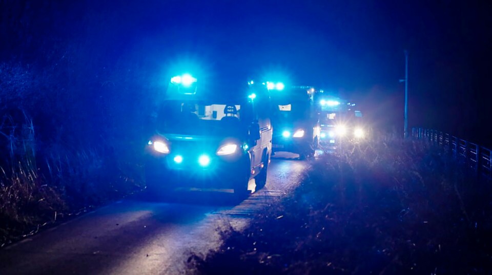 Emergency vehicles driving at night.