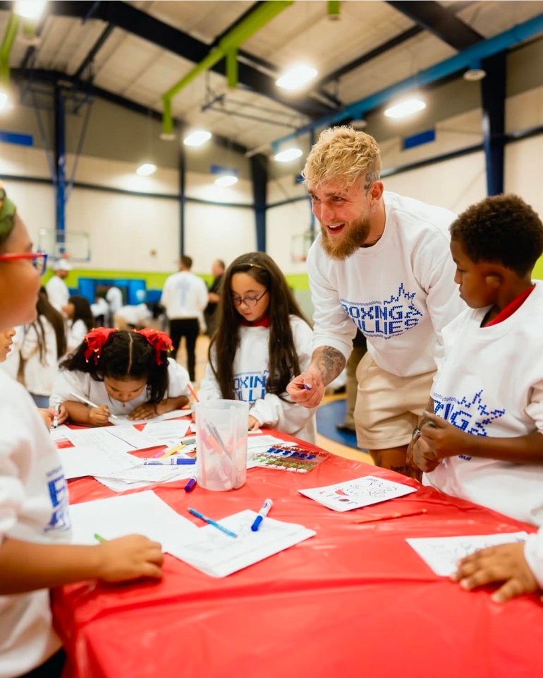 Jake Paul with children doing arts and crafts.