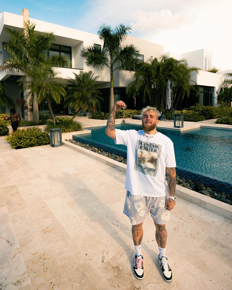 Jake Paul holding keys to his 13 million dollar island mansion.