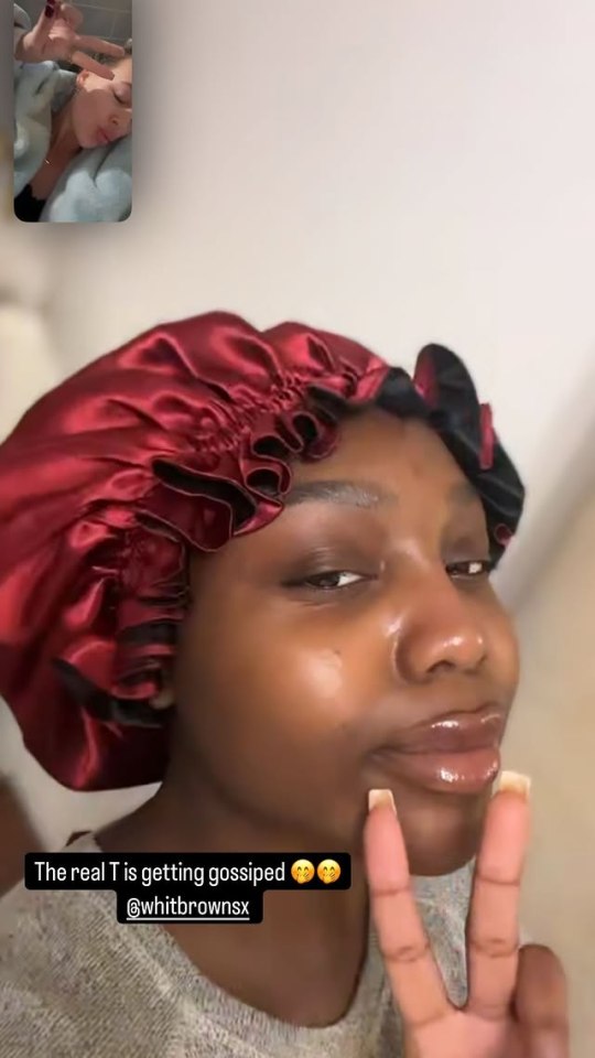 Screenshot of a video showing a woman in a burgundy bonnet reacting to a video call.