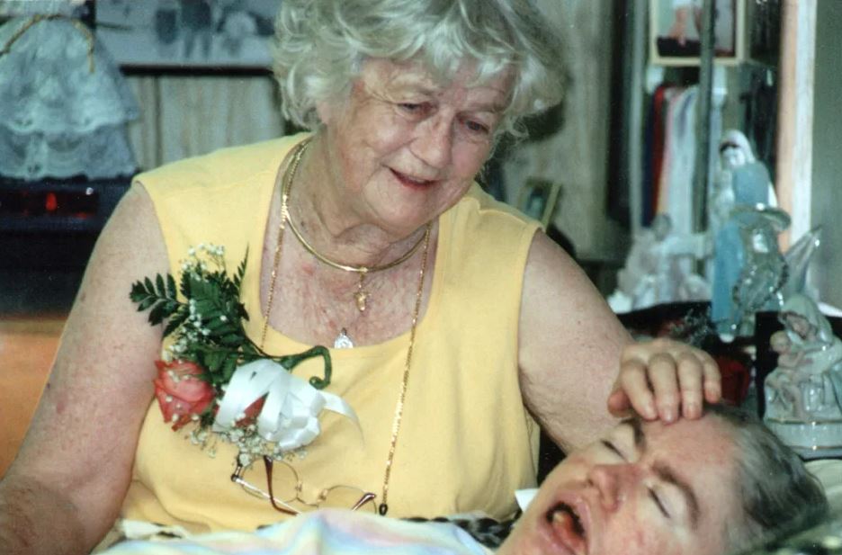 Woman tending to her ill daughter.