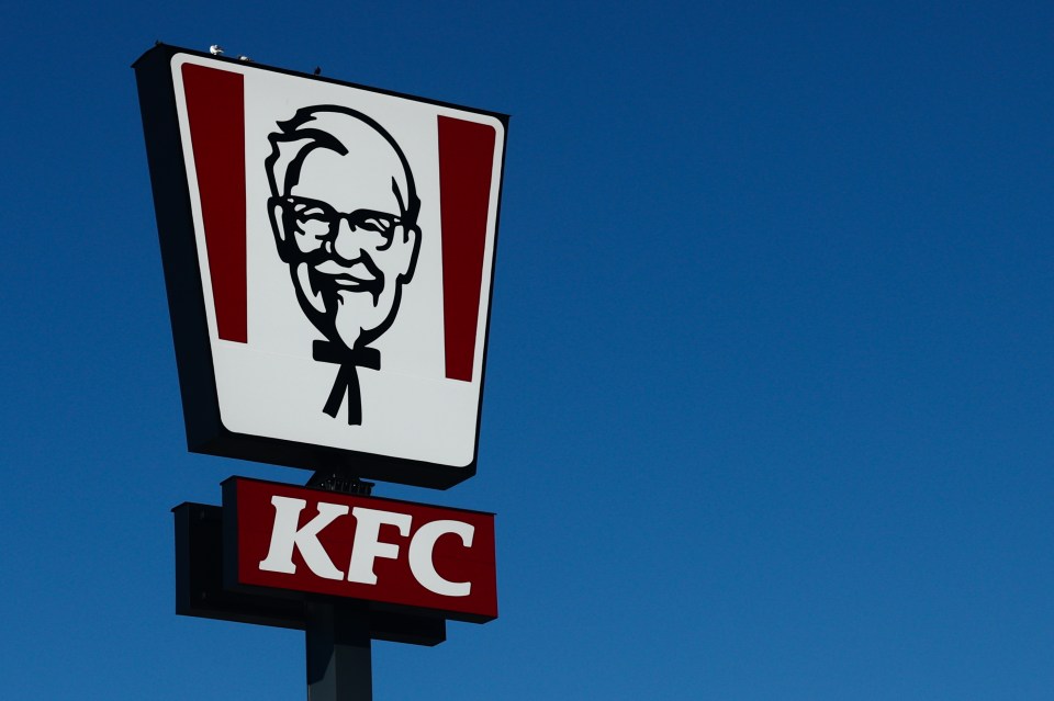 KFC restaurant sign against a blue sky.