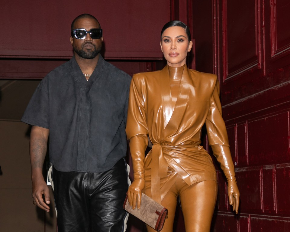 Kim Kardashian and Kanye West leaving a fashion show.