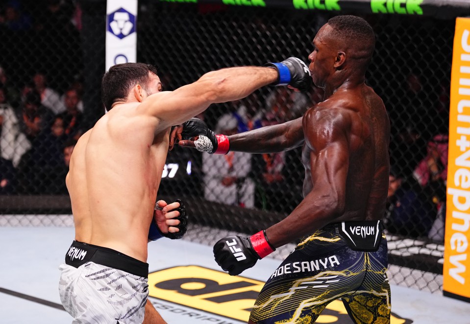 Nassourdine Imavov of Russia punches Israel Adesanya of Nigeria in a UFC middleweight fight.