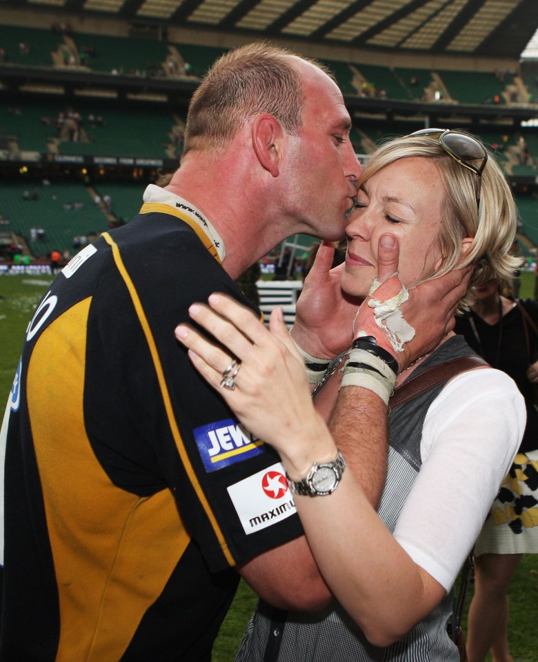 Lawrence Dallaglio of the London Wasps kisses his wife after a rugby match victory.