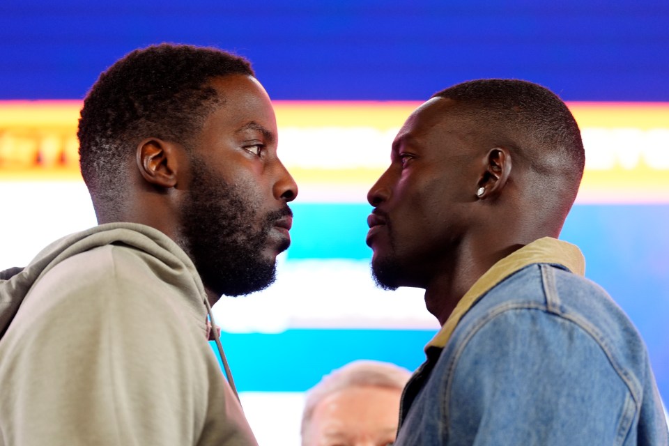 Lawrence Okolie and Richard Riakporhe facing each other at a press conference.