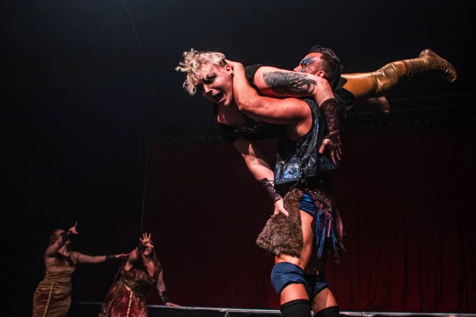 Wrestler carrying another wrestler during a match.