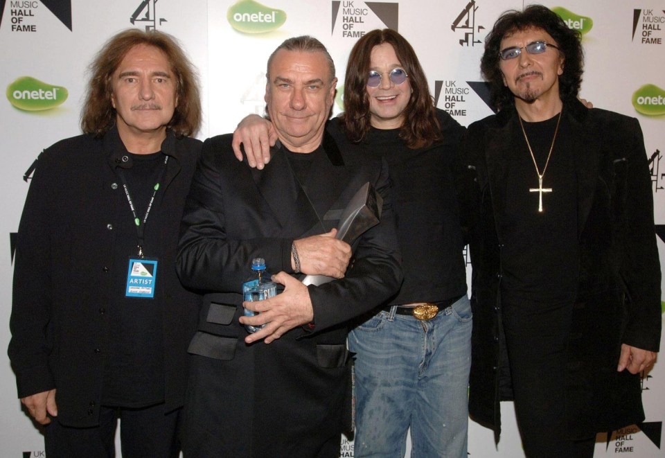 Black Sabbath band members at an awards ceremony.