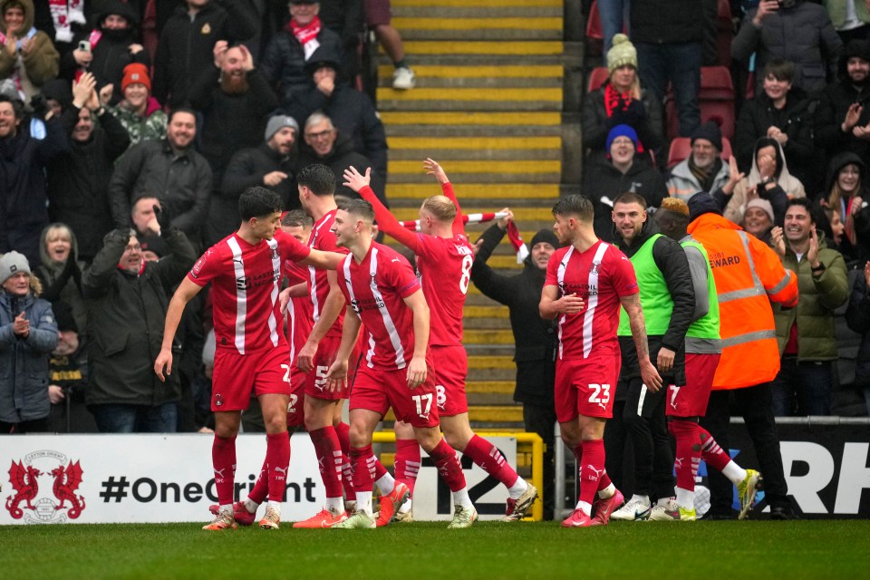 Leyton Orient soccer players celebrating a goal.