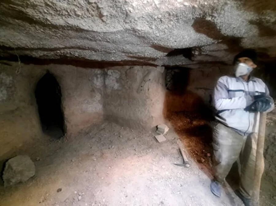 A person explores an ancient underground labyrinth in Abarkuh, Iran.