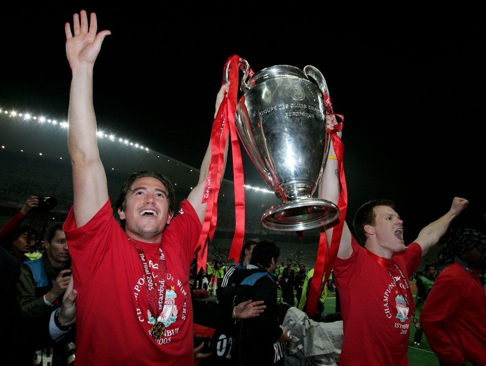 Liverpool players John Arne Riise and Harry Kewell holding the European Champions League trophy.