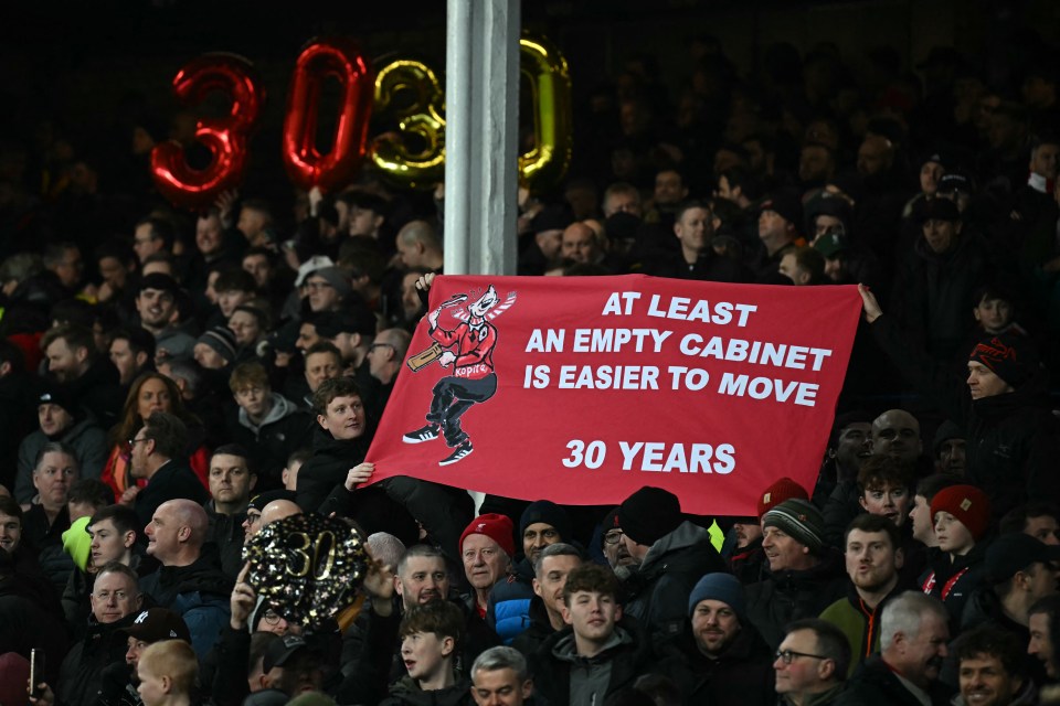 Liverpool fans hold a banner taunting Everton fans about their 30-year trophy drought.