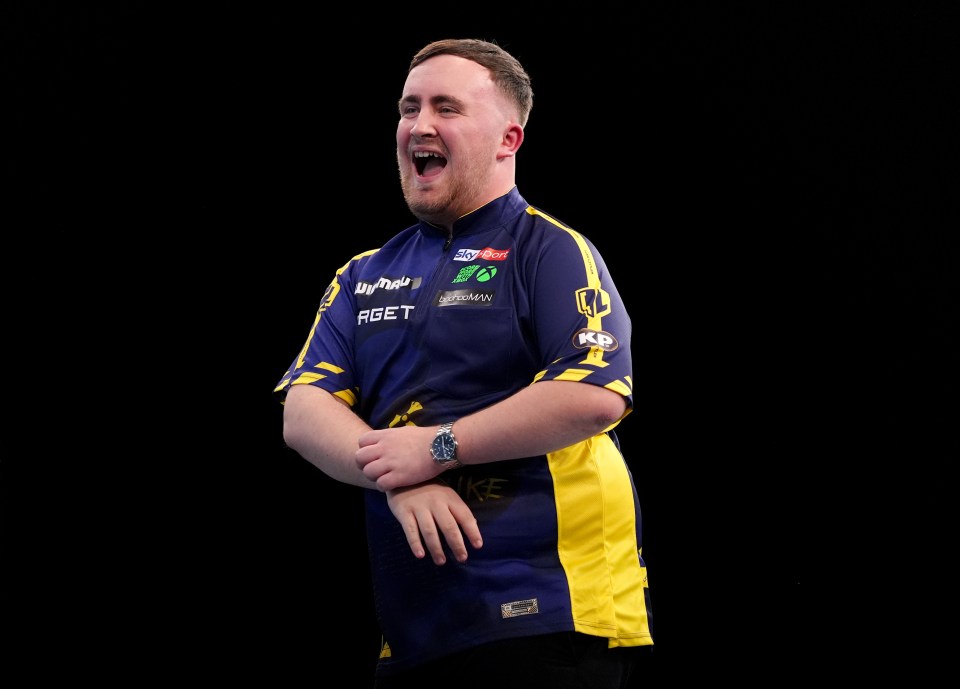 Luke Littler celebrating during a darts match.