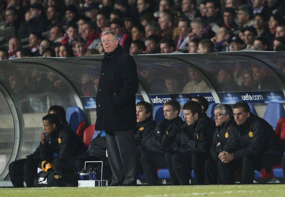 Sir Alex Ferguson, Manchester United's manager, watches a soccer match from the dugout.