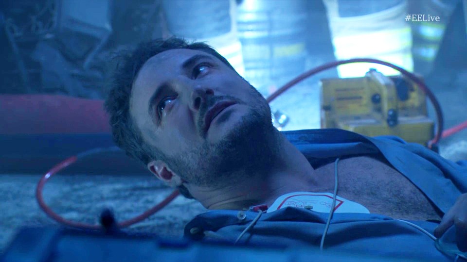 Martin Fowler lying on the ground, hooked up to a defibrillator.