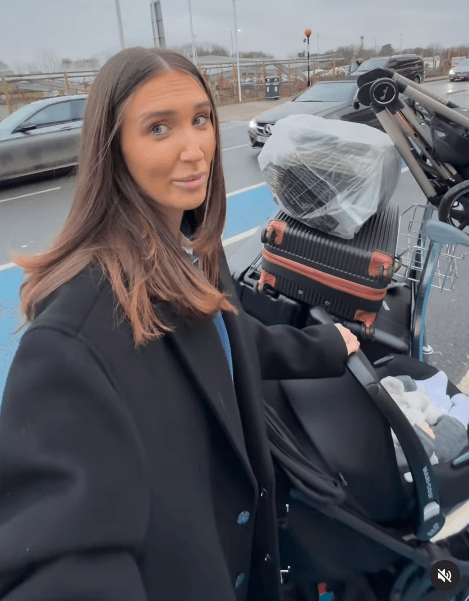 Woman with luggage and stroller at an airport.