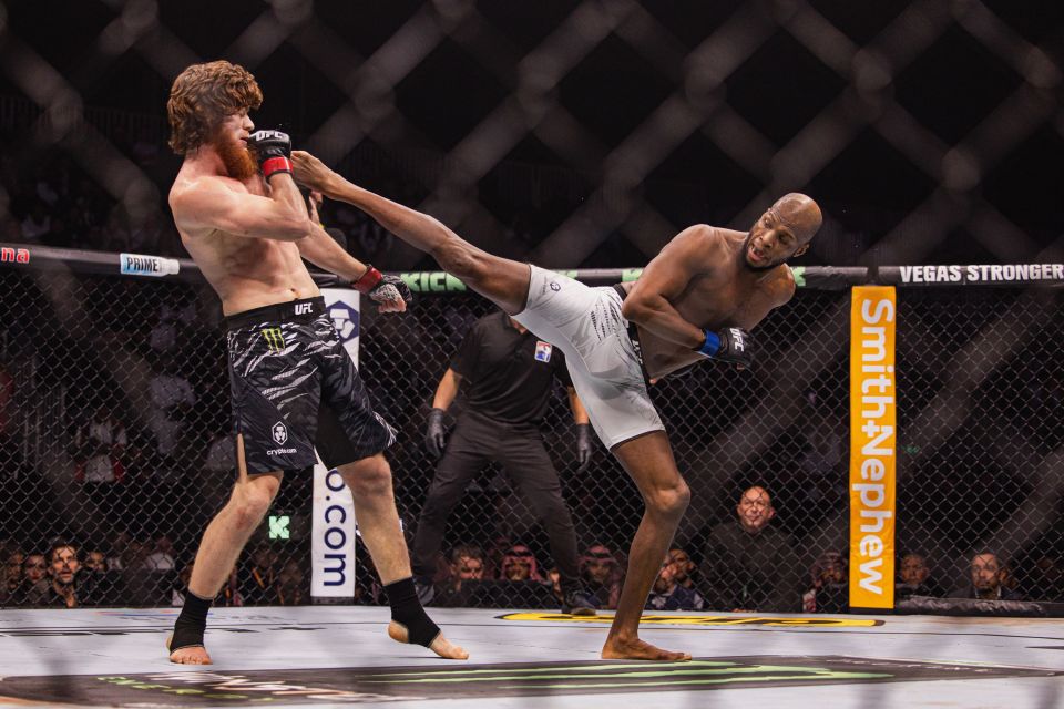 Michael Page throwing a kick at Sharaputdin Magomedov during a UFC fight.