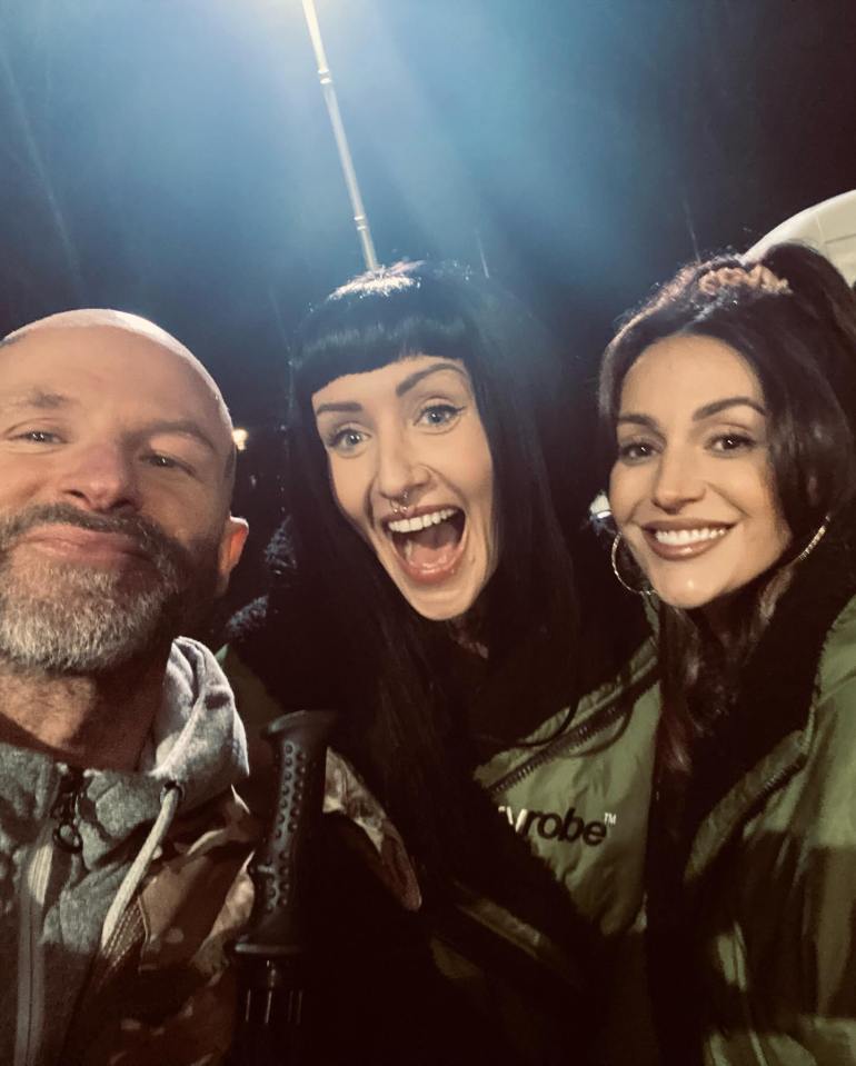 Behind-the-scenes photo of Michelle Keegan with two other people.