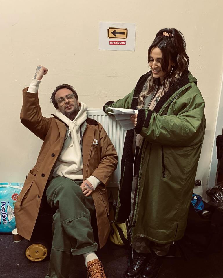 Behind-the-scenes photo of Michelle Keegan and a male castmate on the set of Brassic.