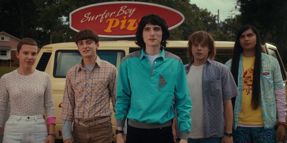 Stranger Things cast members in front of Surfer Boy Pizza van.