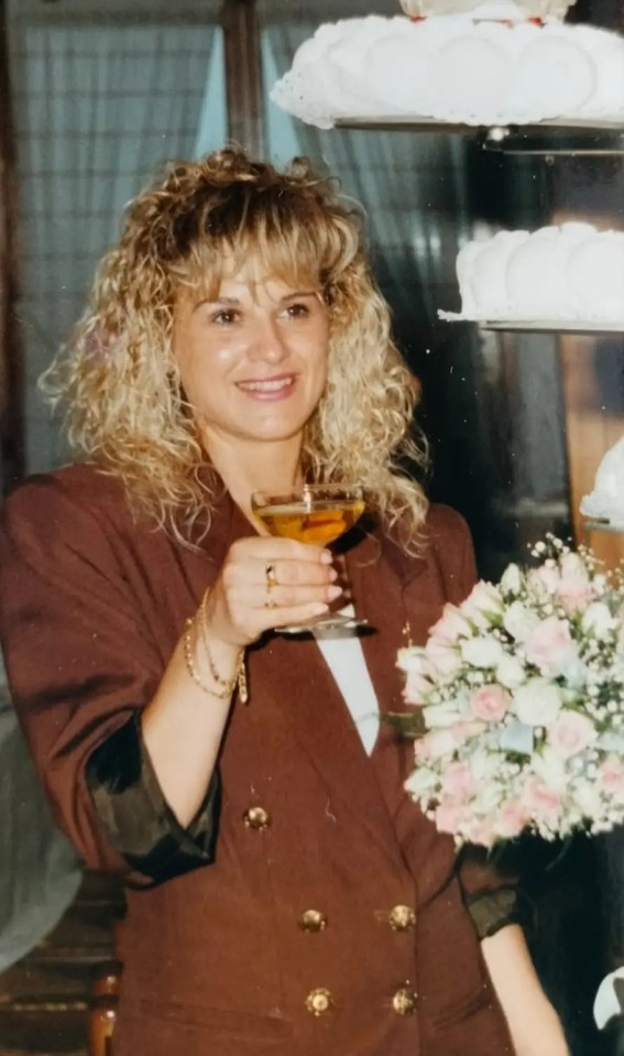 Photo of Luigina Brustolin holding a glass of champagne.