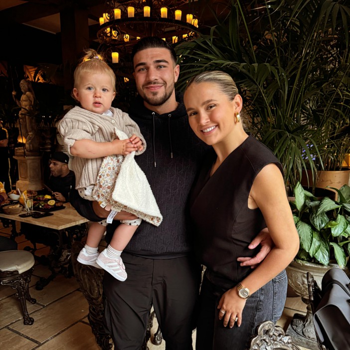 Molly Mae Hague, Tommy Fury, and their baby daughter in a family photo.