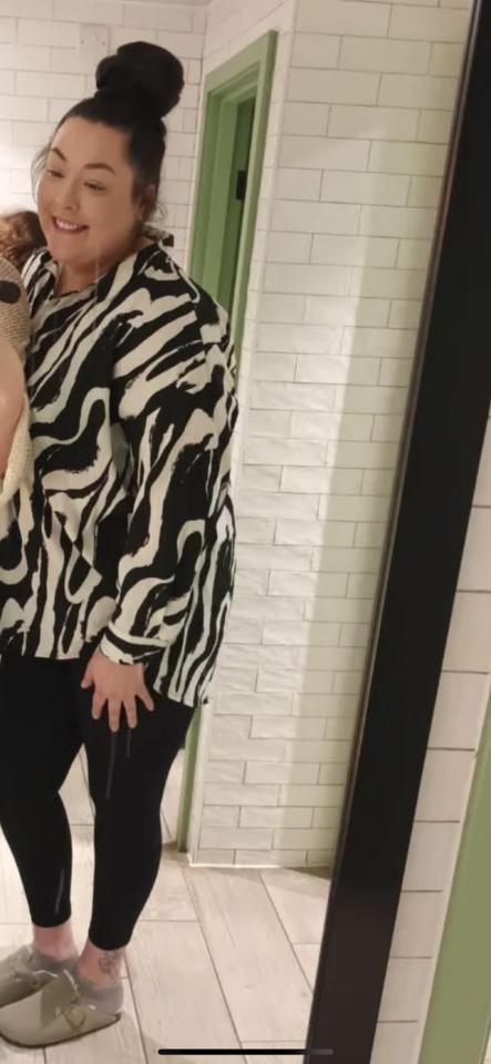 Woman in black and white zebra-print shirt and black leggings.