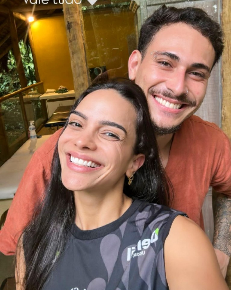 Woman and man smiling for a selfie.