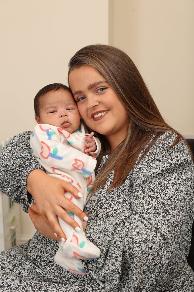 Mother holding her newborn baby daughter.